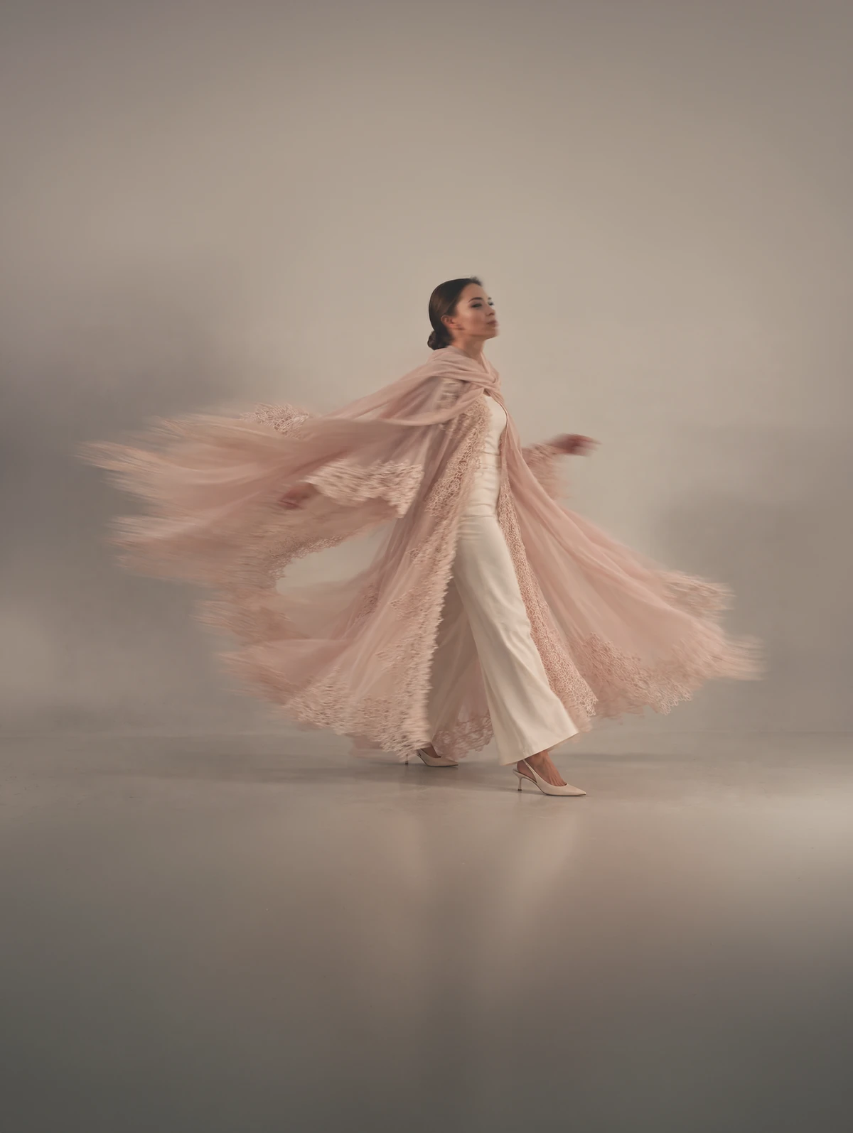 Maward in pale blush, its lace-edged coat and sheila sweeping out behind her.